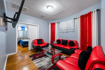 a living room with red chairs and a red couch at Newark 3BR Gem - Near NYC - & Attractions in Newark