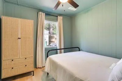a bedroom with a bed and a dresser and a window at Walk to White Lake Family Home with Deck and BBQ in White Lake