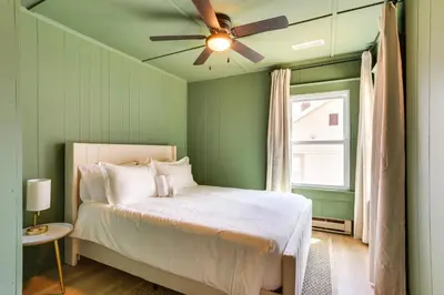a green bedroom with a bed with a ceiling fan at Walk to White Lake Family Home with Deck and BBQ in White Lake