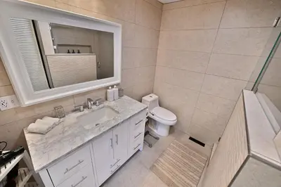 a bathroom with a sink and a toilet and a mirror at Farmhouse in Hershey in Hershey