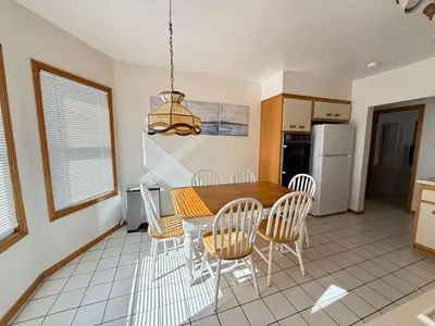 a kitchen with a dining room table and chairs at Cozy 3BR Apartment with Private Entry & Parking in Elizabeth, NJ in Elizabeth