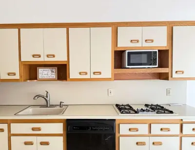a kitchen with a stove and a microwave at Cozy 3BR Apartment with Private Entry & Parking in Elizabeth, NJ in Elizabeth