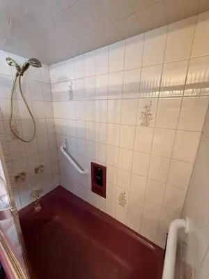 a bathroom with a red tub and a shower at Cozy 3BR Apartment with Private Entry & Parking in Elizabeth, NJ in Elizabeth