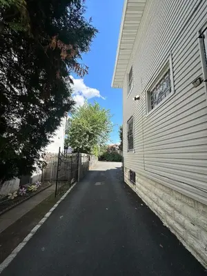 an empty street next to a white building at Cozy 3BR Apartment with Private Entry & Parking in Elizabeth, NJ in Elizabeth