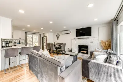 a living room with two couches and a fireplace at Poconos Hot Tub Haven! 14 Mi to Camelback Resort in Pocono Country Place
