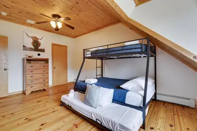 a bedroom with a bunk bed and a ceiling fan at Secluded Escape - PAN's Wooden Casita in Lake Ariel