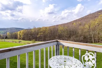 a white chair sitting on a balcony with a view at Cozy Andes Cabin with Scenic Views in Andes