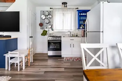a kitchen with white appliances and a table and chairs at Cozy Andes Cabin with Scenic Views in Andes