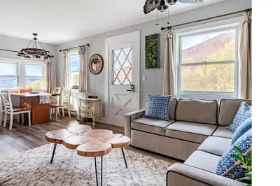 a living room with a couch and a table at Cozy Andes Cabin with Scenic Views in Andes