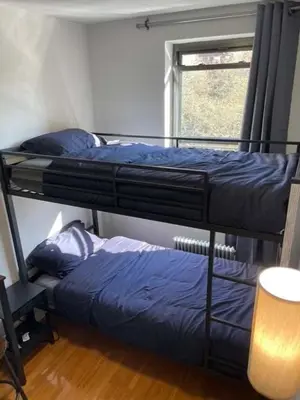 two bunk beds in a room with a window at Chelsea Studio 5 - Shared Bathroom - 5th Floor Walk Up in New York