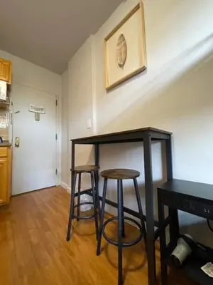 two bar stools in a living room with a table at Chelsea Studio 5 - Shared Bathroom - 5th Floor Walk Up in New York