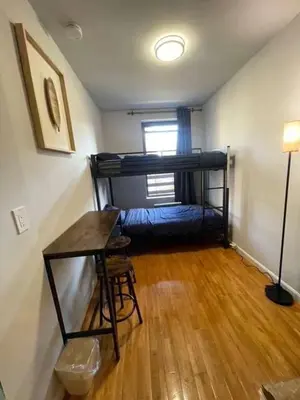 a room with a bunk bed and a table in it at Chelsea Studio 5 - Shared Bathroom - 5th Floor Walk Up in New York