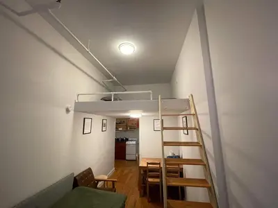 a room with a loft bed and a kitchen at Union Square Studio 4 with Shower - Shared toilet in New York
