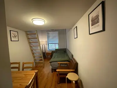 a small room with a bed and a staircase at Union Square Studio 4 with Shower - Shared toilet in New York