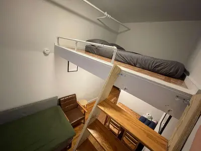 a room with a bunk bed and a couch at Union Square Studio 4 with Shower - Shared toilet in New York
