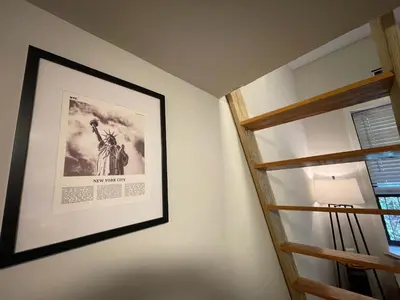 a picture of the statue of liberty on a wall next to a window at Union Square Studio 4 with Shower - Shared toilet in New York