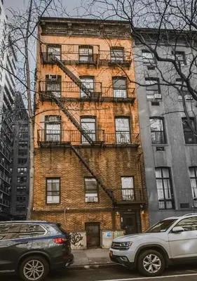 a brick building with fire escapes on the side of it at Union Square Studio 4 with Shower - Shared toilet in New York