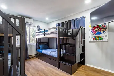a room with three bunk beds in a room at Poconos Pines Retreat getaway near top attractions in Pocono Summit