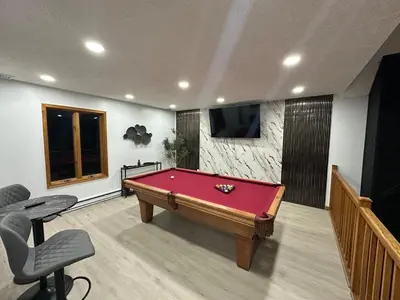 a room with a pool table and a tv at Beautiful Modern Lodge! Game Room in Saw Creek