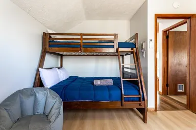 a bedroom with two bunk beds and a couch at Modern Rustic Lodge! Game Room in Saw Creek