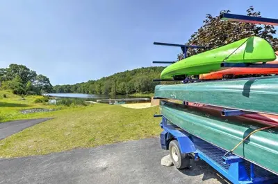 a pile of kayaks sitting on top of a truck at Modern Rustic Lodge! Game Room in Saw Creek