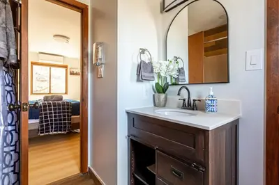 a bathroom with a sink and a mirror at Modern Rustic Lodge! Game Room in Saw Creek