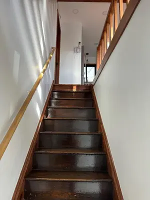 a staircase in a house with wooden steps at Modern Rustic Lodge! Game Room in Saw Creek