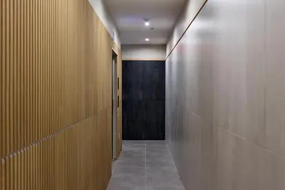 a corridor with wooden walls and a hallway with a corridorngthngthngth at Sunny 2BR Loft • Work Relax Minutes to NYC in Hoboken