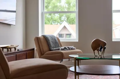 a living room with a couch and a chair and a table at Sunny 2BR Loft • Work Relax Minutes to NYC in Hoboken