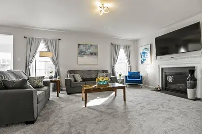 a living room with a couch and a table at Spacious & Serene Family Gem: Games, Office, Yard! in Pennsburg