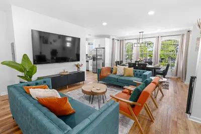 a living room with two blue couches at NYC 20min Free Parking Hot Tub EWR 15min in Bayonne