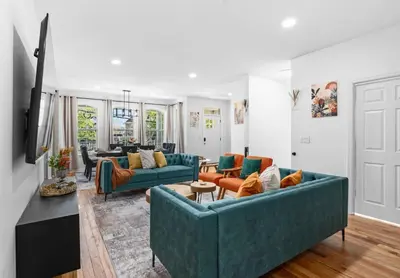 a living room with two blue couches at NYC 20min Free Parking Hot Tub EWR 15min in Bayonne