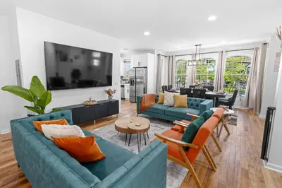 a living room with two blue couches at NYC 20min Free Parking Hot Tub EWR 15min in Bayonne