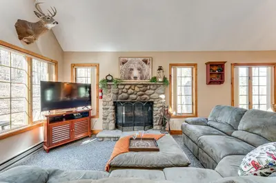a living room with a couch and a fireplace at Access to Jack Frost Ski Resort Home with Hot Tub in White Haven