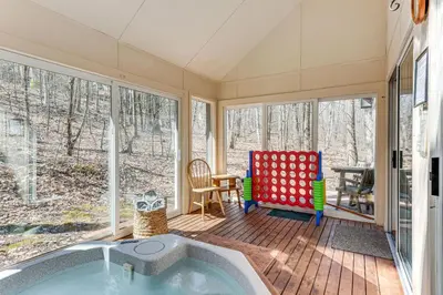 a house with a tub in a room with windows at Access to Jack Frost Ski Resort Home with Hot Tub in White Haven