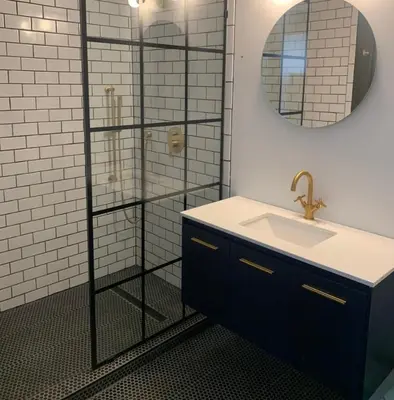 a bathroom with a sink and a glass shower at The Rest Suite 5 in Kenoza Lake