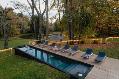 a deck with lounge chairs and a swimming pool at The Rest Suite 5 in Kenoza Lake