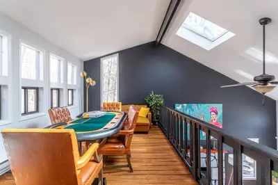 a dining room with a table and chairs at Mahogany Sun Hot Tub Theater Room Fire Pit in East Stroudsburg