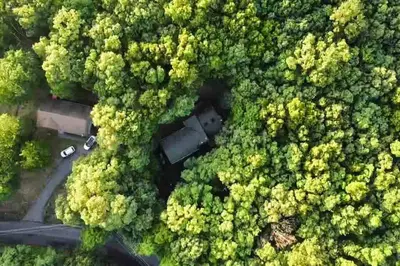an aerial view of a car parked in a forest at Twin Pines Retreat Hot Tub Theater Room Fire in East Stroudsburg