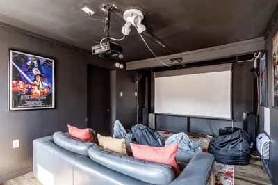 a living room with a blue couch in a trailer at Twin Pines Retreat Hot Tub Theater Room Fire in East Stroudsburg