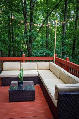 a patio with a couch and a table on a deck at Twin Pines Retreat Hot Tub Theater Room Fire in East Stroudsburg