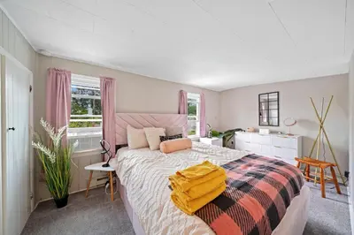 a bedroom with a large bed with a colorful blanket at Comfort, Fun, and Retro Retreat in Royersford