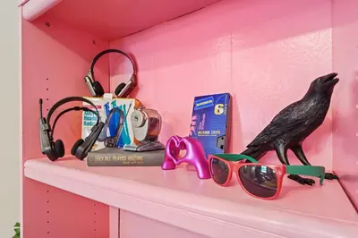 a shelf with a bird and sunglasses on it at Comfort, Fun, and Retro Retreat in Royersford