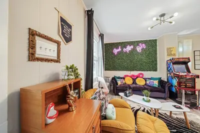 a living room with a couch and a table at Comfort, Fun, and Retro Retreat in Royersford