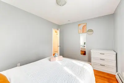 a white bedroom with a white bed and a dresser at Game Room, Deck and Fire Pit Covington Township Gem in Daleville