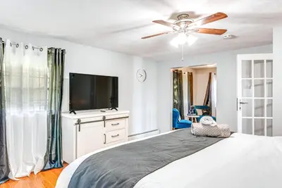a bedroom with a bed with a ceiling fan and a tv at Game Room, Deck and Fire Pit Covington Township Gem in Daleville