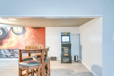 a room with a table and two stools at Game Room, Deck and Fire Pit Covington Township Gem in Daleville