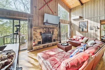 a living room with a couch and a fireplace at Charming Porter House in the heart of the Poconos chalet in East Stroudsburg