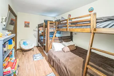 a bedroom with two bunk beds and a desk at Charming Porter House in the heart of the Poconos chalet in East Stroudsburg