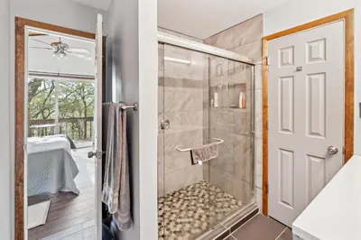 a bathroom with a shower with a glass door at Charming Porter House in the heart of the Poconos chalet in East Stroudsburg
